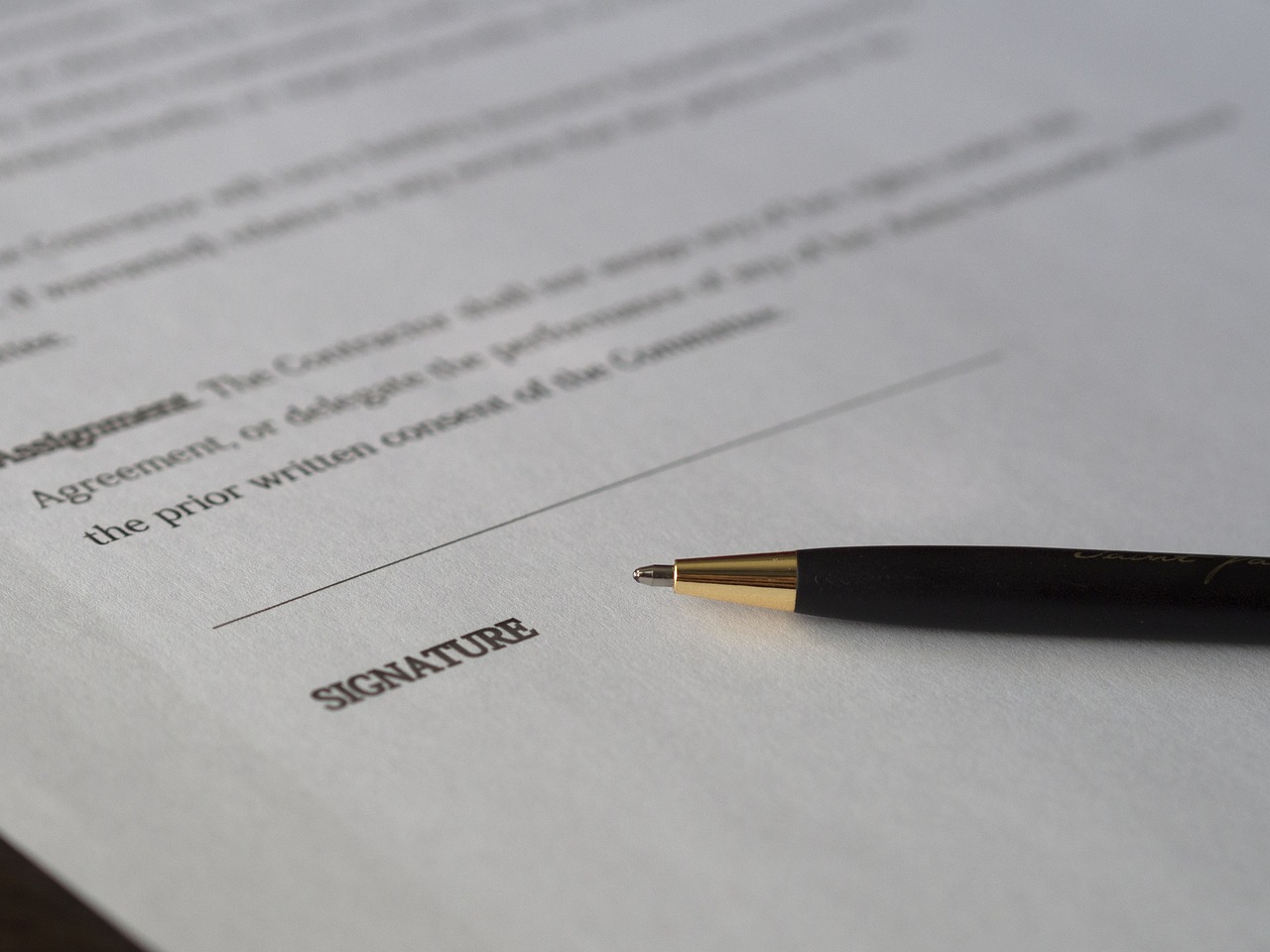 Contract signature page and pen