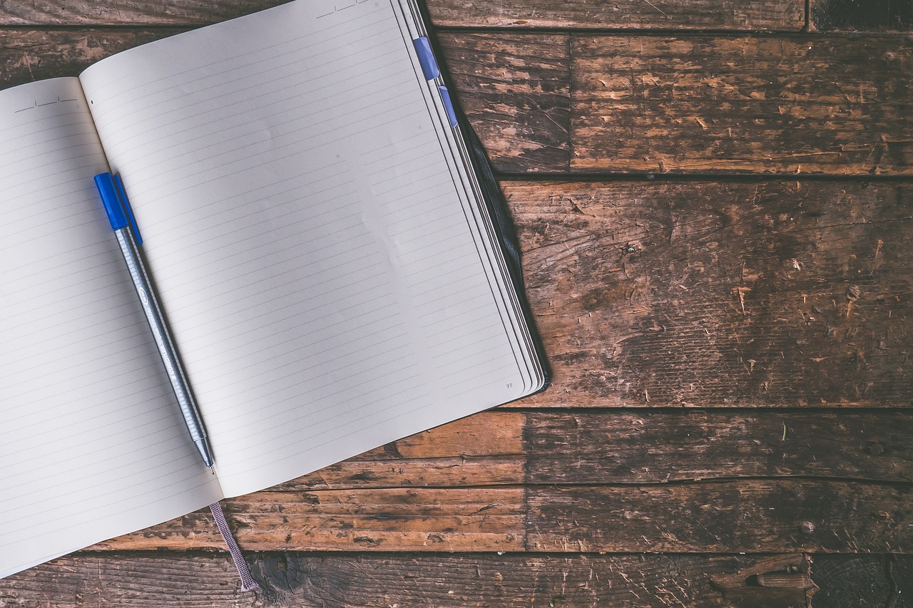 A blank notebook page and pen